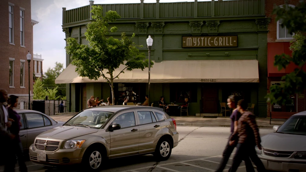 Exterior of the Mystic Grill. A restaurant with a green marquee.